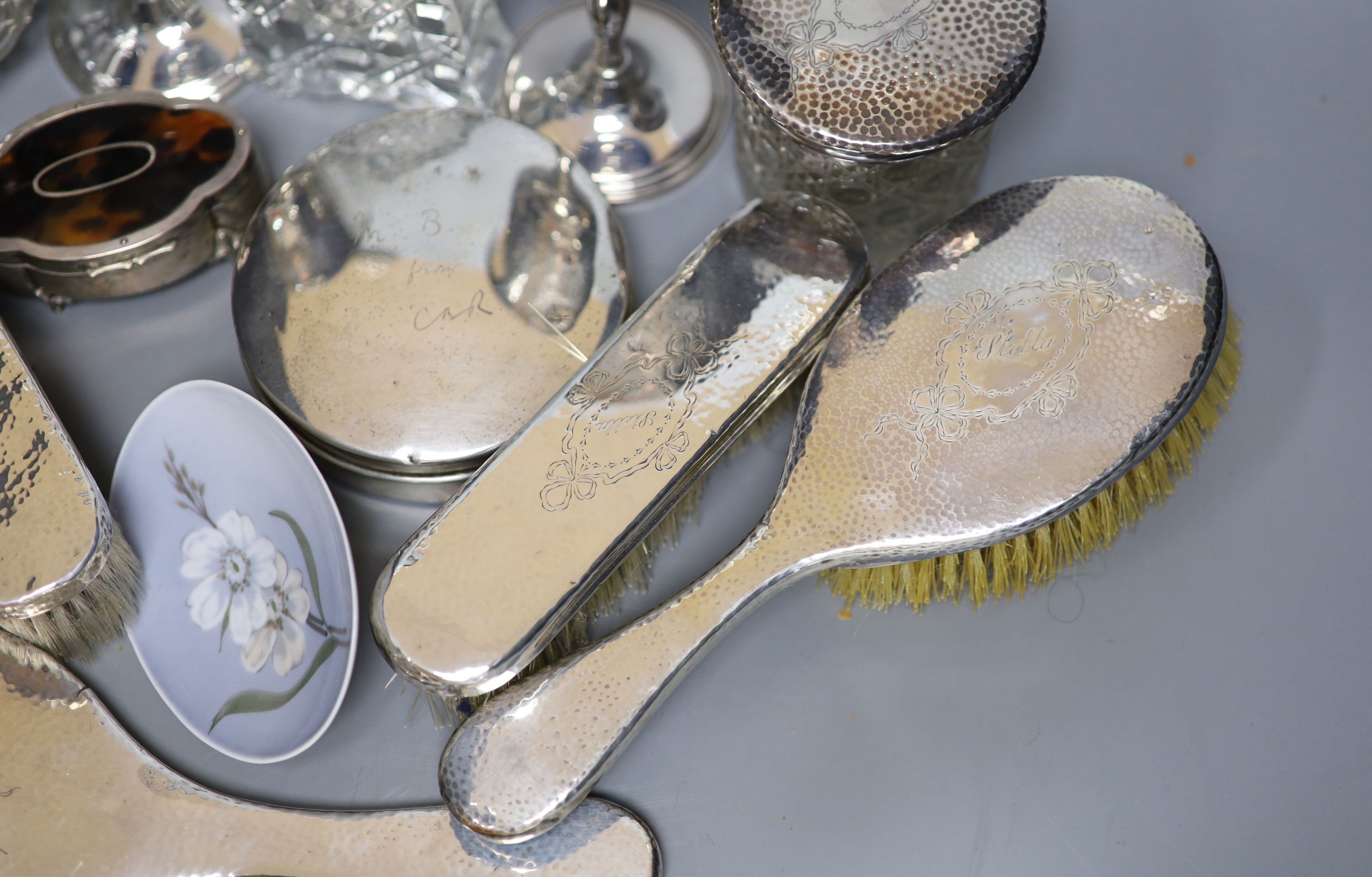 A George V hammered silver ten piece dressing table set with tray, engraved 'Stella' and six other items including a silver circular powder box?, a tortoiseshell mounted trinket box and two plate goblets.